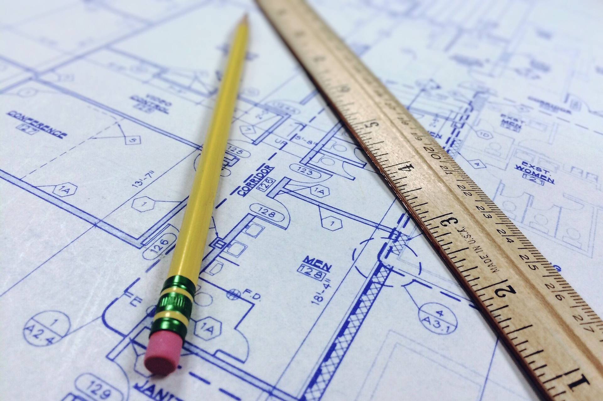 Photograph of blueprints, a pencil and a ruler