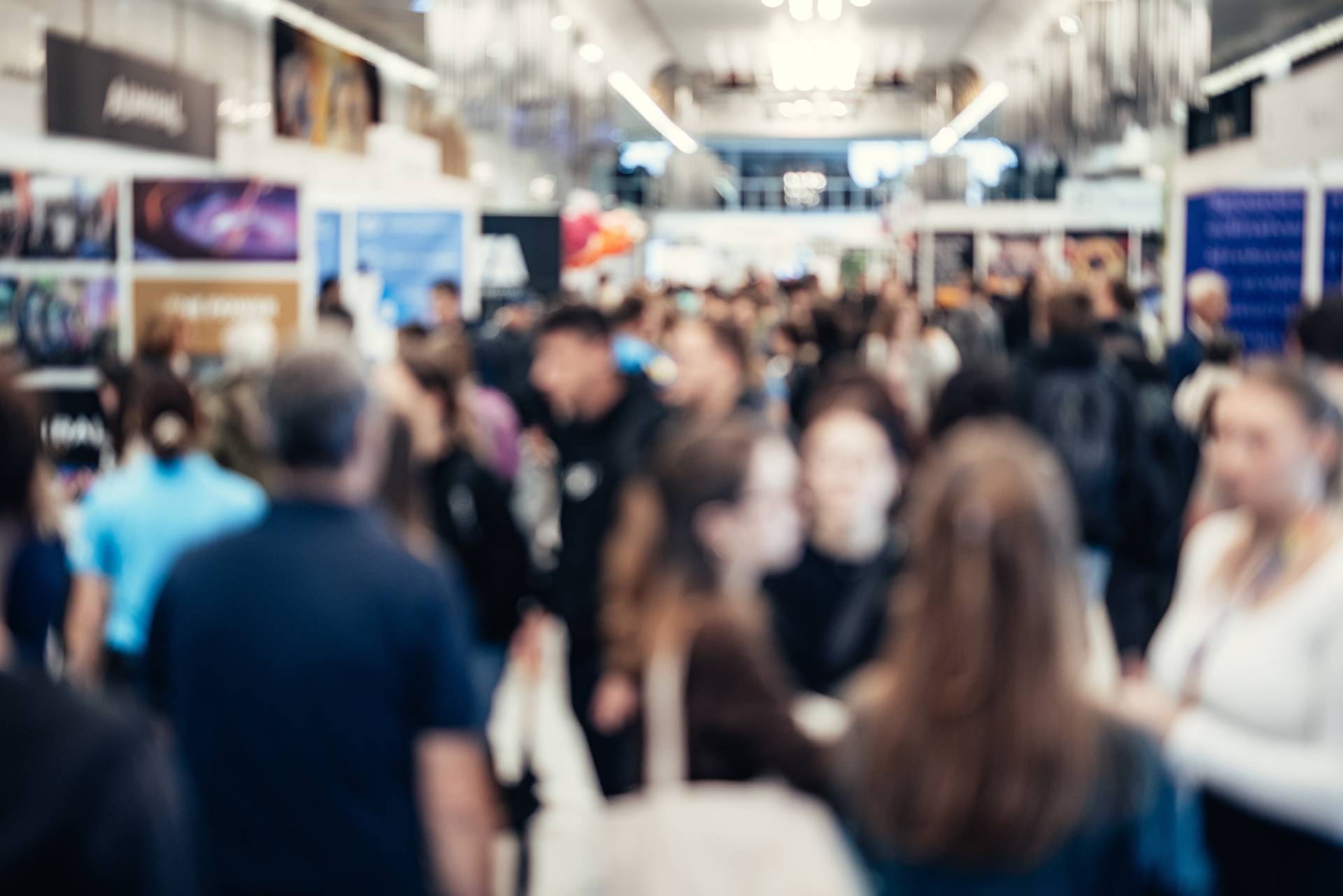 Photograph of a large exhibition hall, filled with people